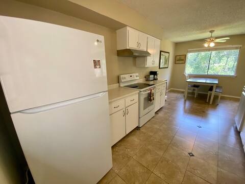 903 The High Road Austin, TX 78746 - Photo 5 of 39 a kitchen with stainless steel appliances a refrigerator sink and white cabinets