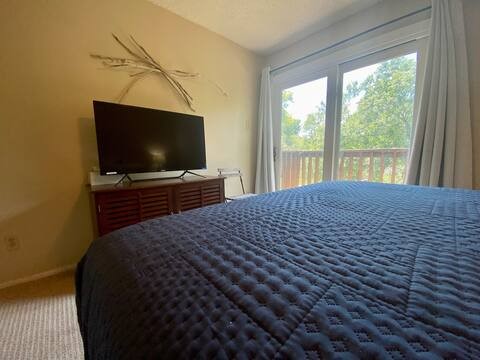 903 The High Road Austin, TX 78746 - Photo 6 of 39 a bedroom with a bed and a flat screen tv