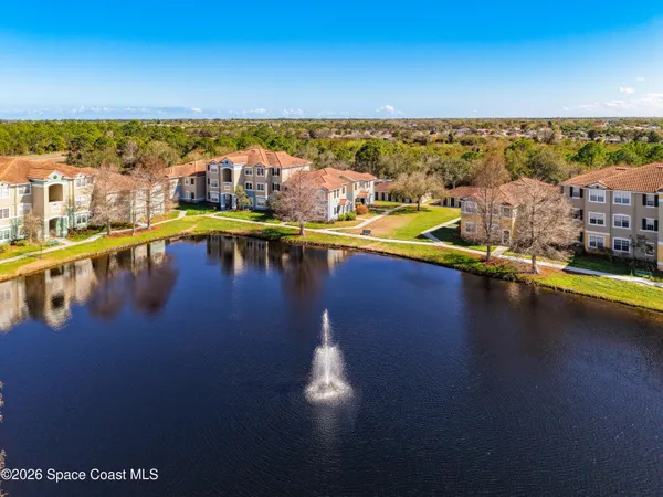 an aerial view of a house with a ocean view