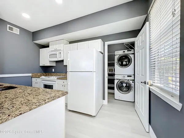 a kitchen with a refrigerator and a stove top oven