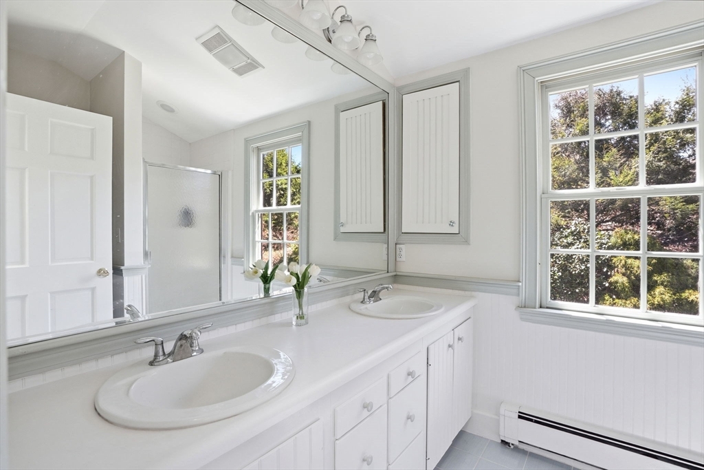 34 Governor Long Road Hingham, MA 02043 - Photo 23 of 37 a bathroom with a double vanity sink and a mirror