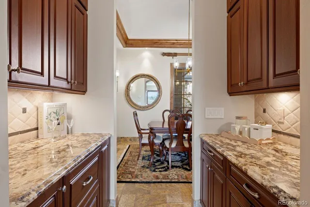 a view of a dining room and livingroom with furniture wooden floor a chandelier