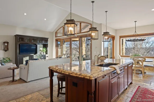 a kitchen with granite countertop a stove and a wooden cabinets