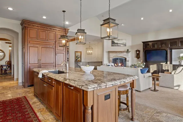 a kitchen with center island table and chairs in it