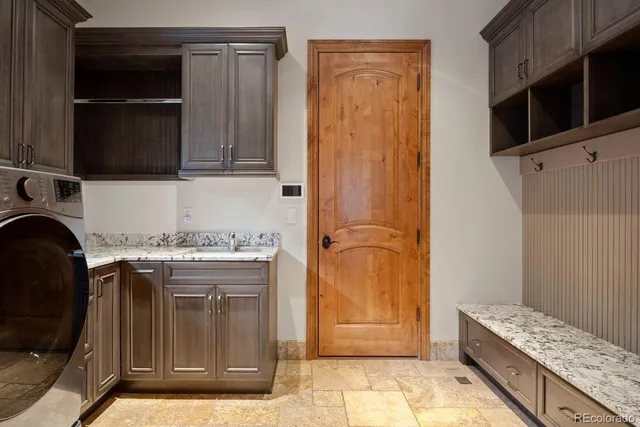 a living room with furniture a fireplace and kitchen view