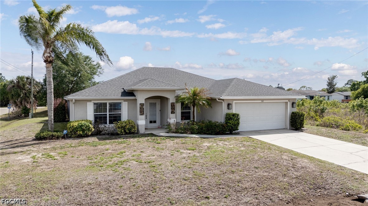 3801 28th Street Southwest Lehigh Acres, FL 33976 - Photo 3 of 37 a front view of a house with a yard