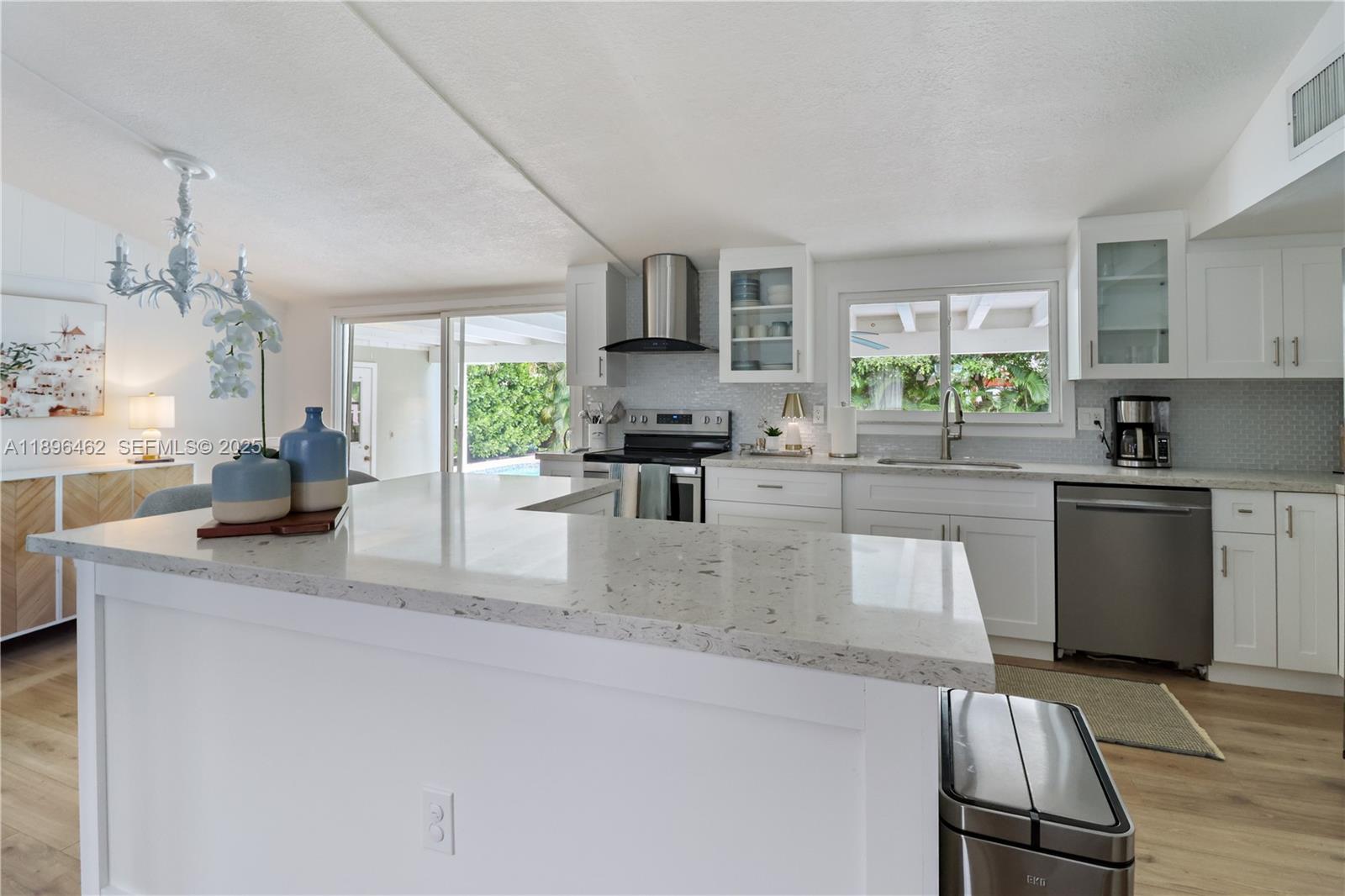 5055 Garfield Road Delray Beach, FL 33484 - Photo 5 of 29 a kitchen with stainless steel appliances granite countertop a sink stove and refrigerator