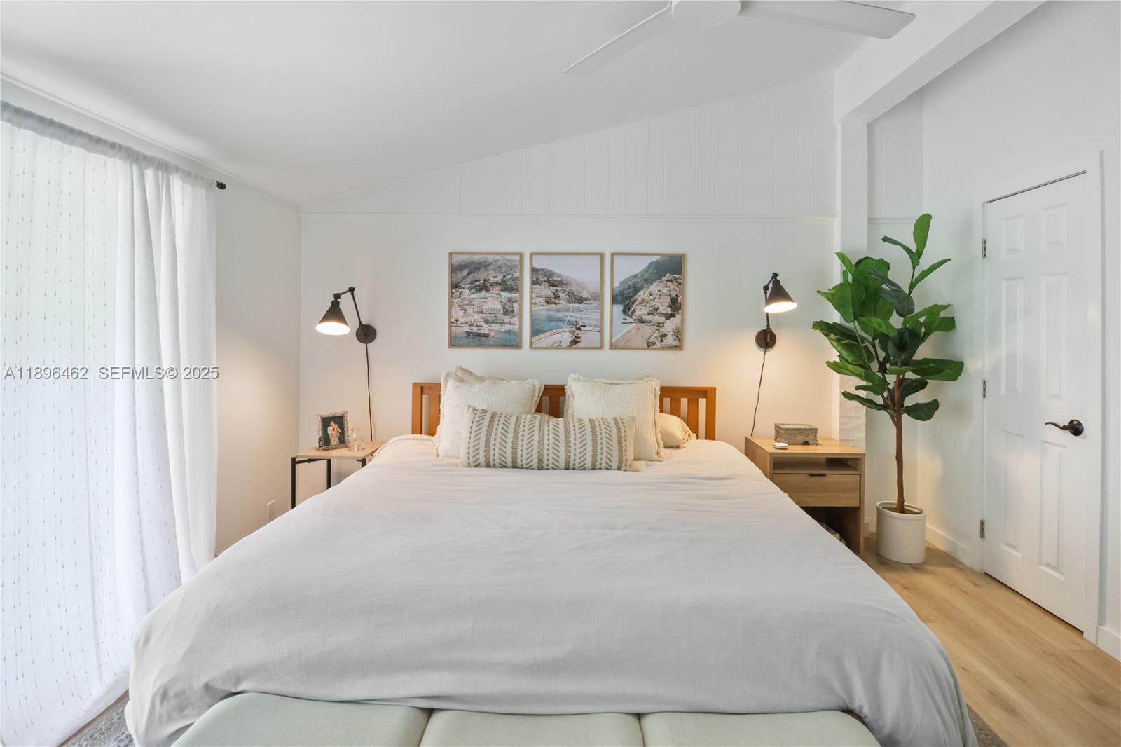 5055 Garfield Road Delray Beach, FL 33484 - Photo 8 of 29 a bedroom with a large bed and a potted plant