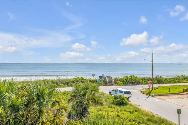a view of a dining room with furniture a chandelier and wooden floor