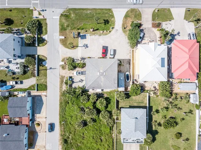 a front view of residential houses with yard and green space