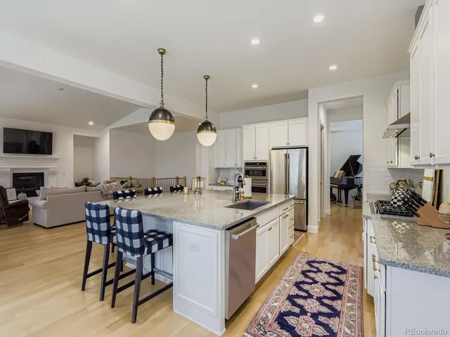 a large kitchen with a table and chairs