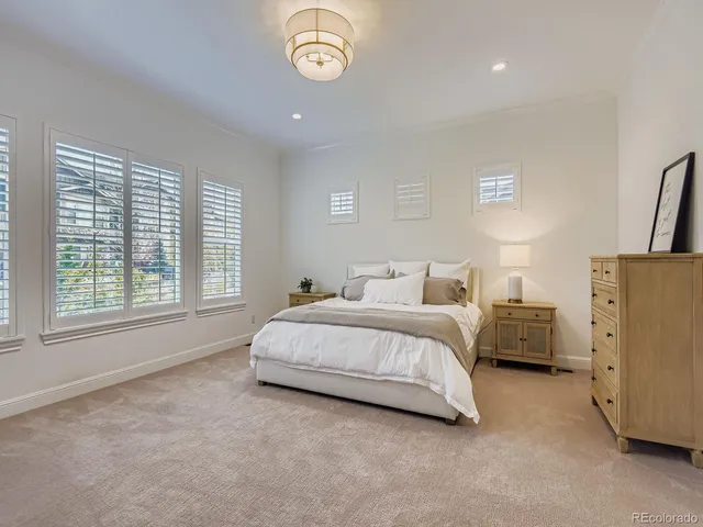 a spacious bedroom with a bed and a large window
