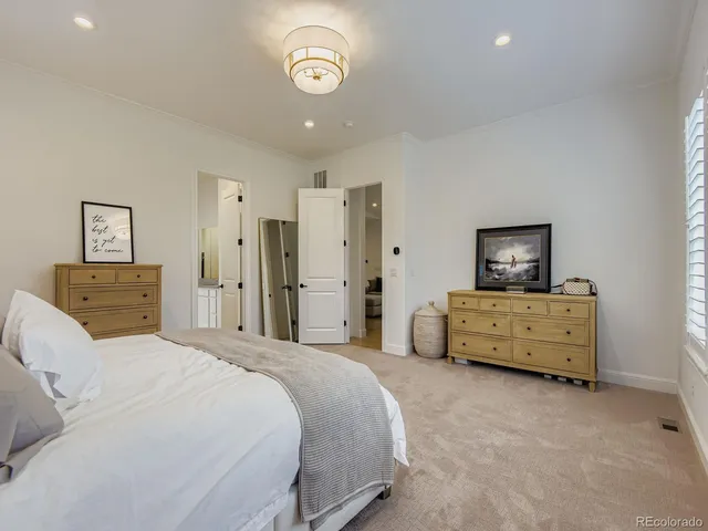 a bedroom with a bed and a couch