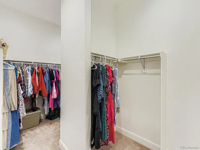 a view of walk in closet with clothes