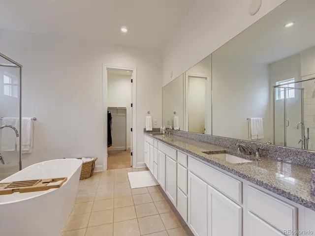 a spacious bathroom with a granite countertop sink and a mirror