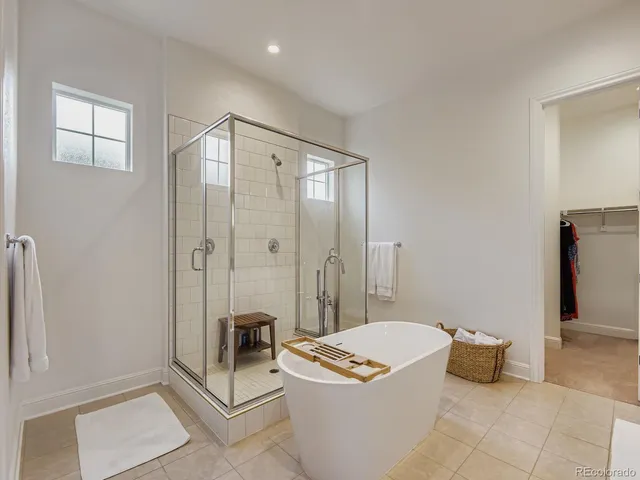 a spacious bathroom with a tub and shower