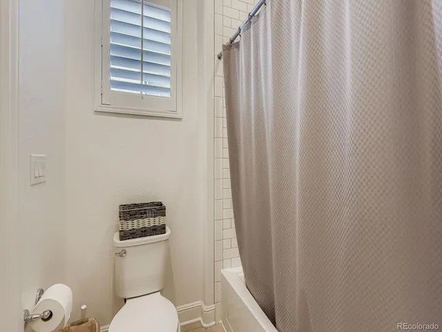 a white toilet sitting next to a small bathroom