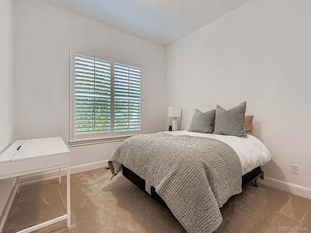 a spacious bedroom with a bed and a window