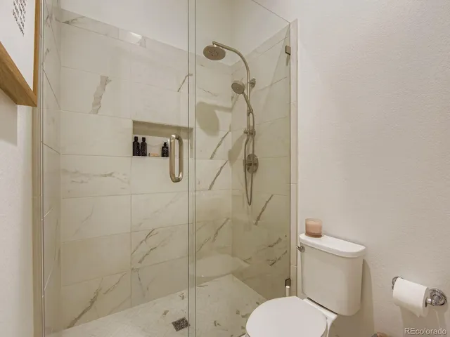 a white toilet sitting next to a bathroom sink