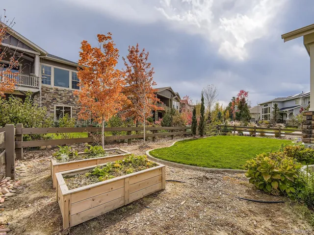 a view of a garden with tall buildings