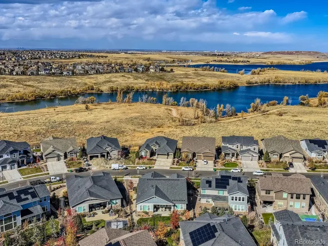 a view of a lake with lawn chairs
