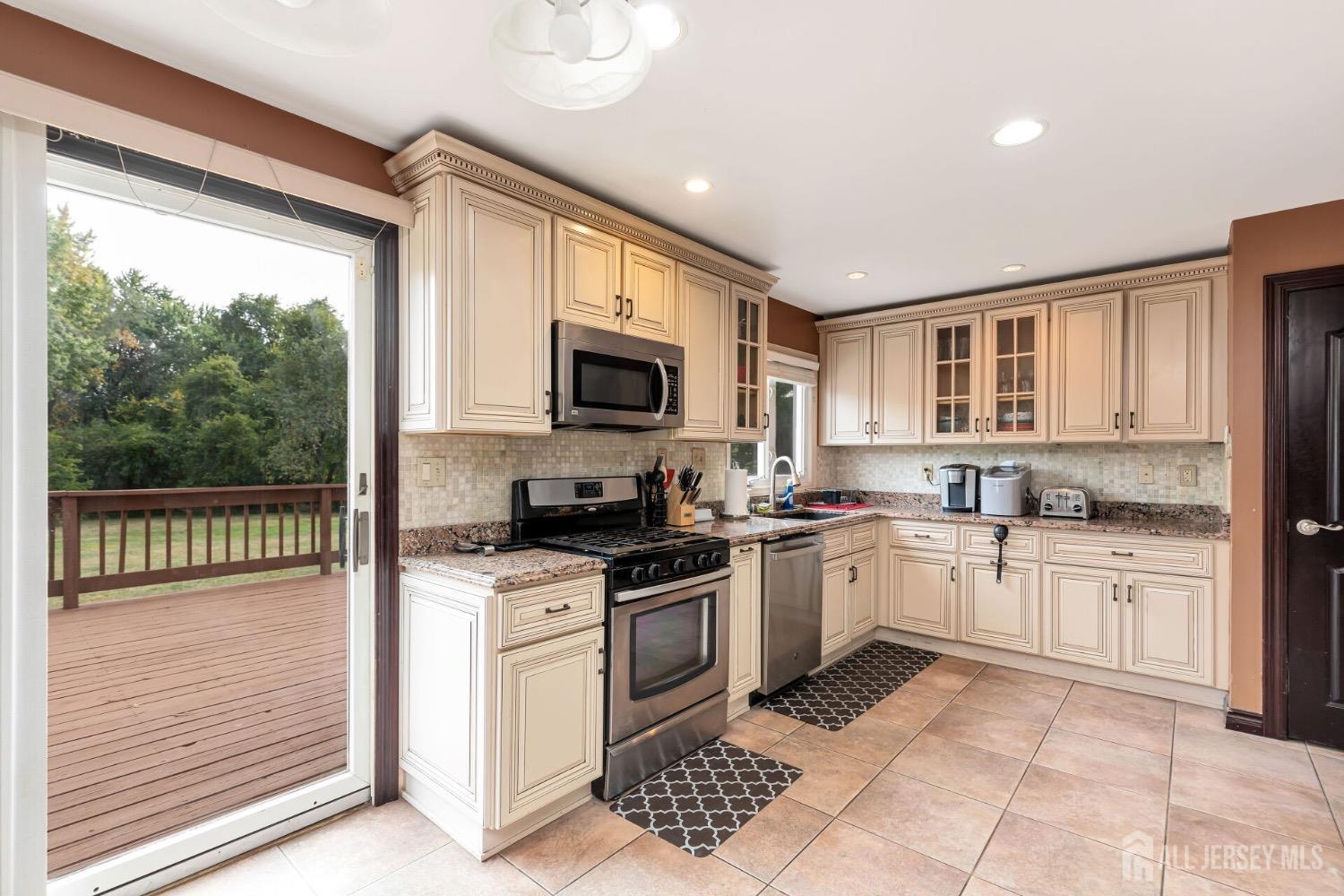 321 Overbrook Road Piscataway, NJ 08854 - Photo 12 of 46 a kitchen with granite countertop a stove top oven microwave and cabinets