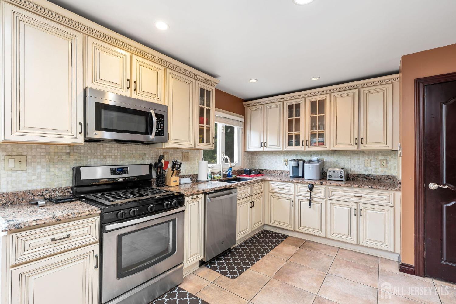 321 Overbrook Road Piscataway, NJ 08854 - Photo 13 of 46 a kitchen with stainless steel appliances granite countertop a sink and cabinets