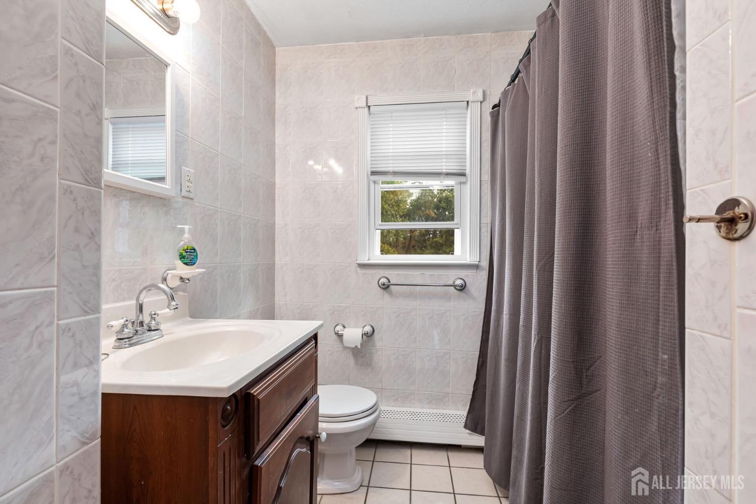 321 Overbrook Road Piscataway, NJ 08854 - Photo 18 of 46 a bathroom with a sink toilet and a mirror