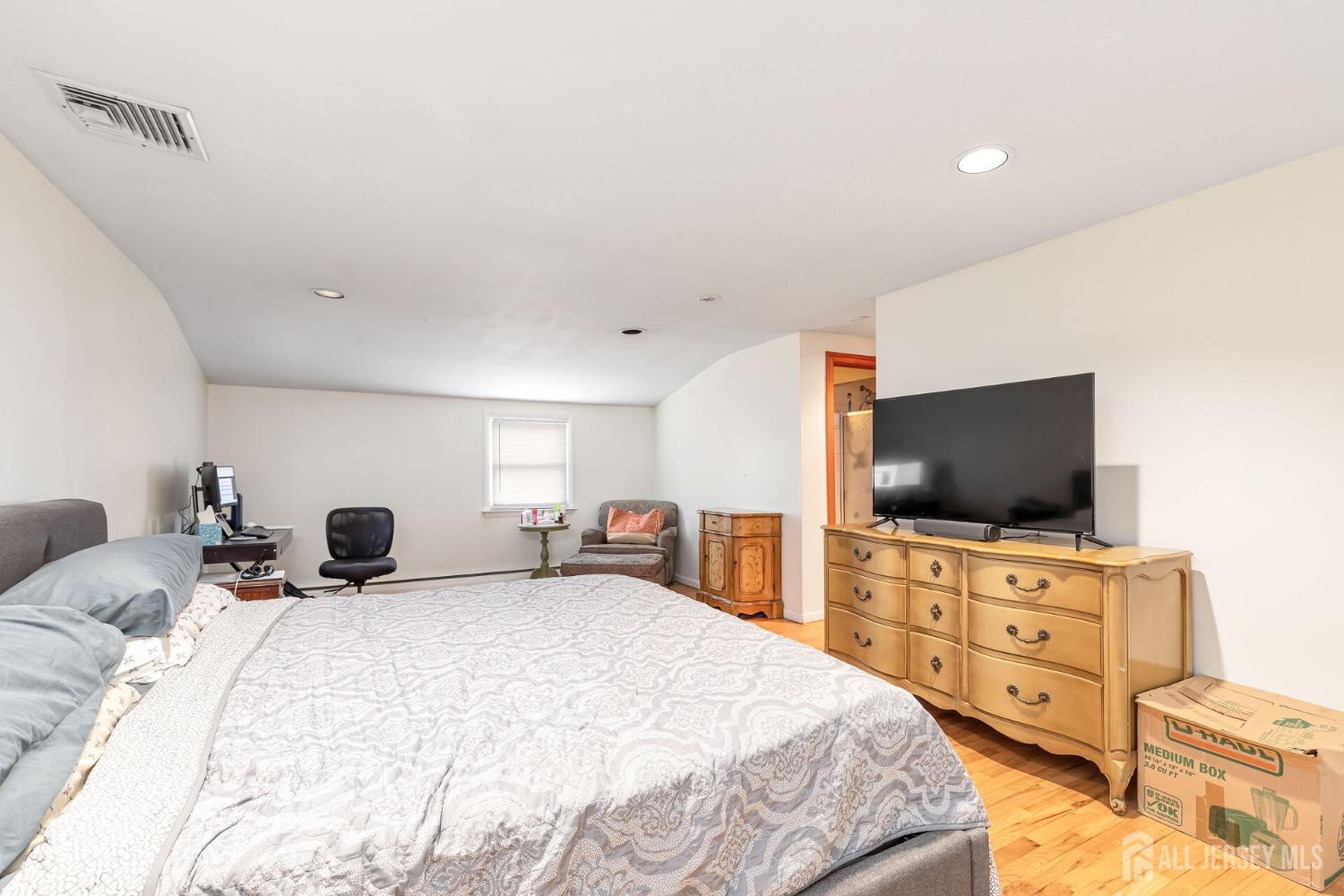 321 Overbrook Road Piscataway, NJ 08854 - Photo 20 of 46 a bedroom with a bed and a flat screen tv