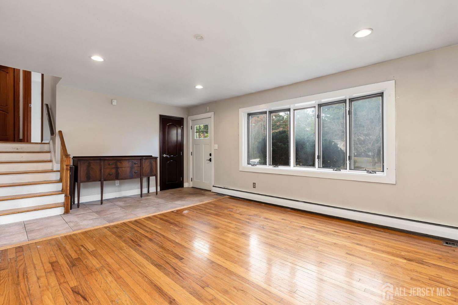 321 Overbrook Road Piscataway, NJ 08854 - Photo 7 of 46 a view of an empty room with a window and wooden floor