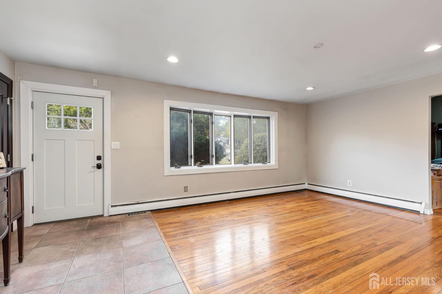 321 Overbrook Road Piscataway, NJ 08854 - Photo 9 of 46 a view of an empty room with wooden floor and a window