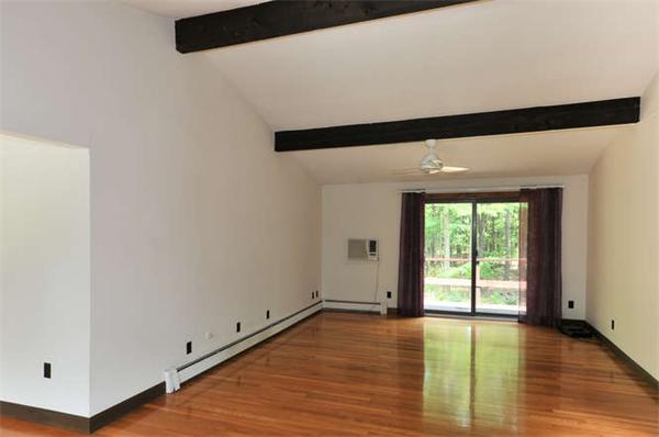 453 Harvard Road Bolton, MA 01740 - Photo 8 of 20 a view of an empty room with wooden floor and a window