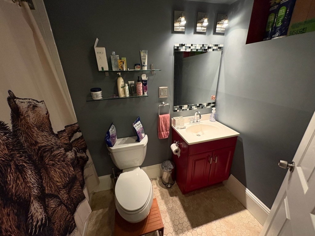 222 Pearl Street, Unit 2 Somerville, MA 02145 - Photo 14 of 15 a bathroom with a toilet sink and mirror