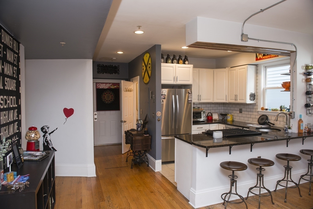 222 Pearl Street, Unit 2 Somerville, MA 02145 - Photo 3 of 15 a kitchen with a sink appliances cabinets and dining table