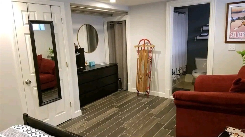 222 Pearl Street, Unit 2 Somerville, MA 02145 - Photo 8 of 15 a bedroom with a bed and a mirror
