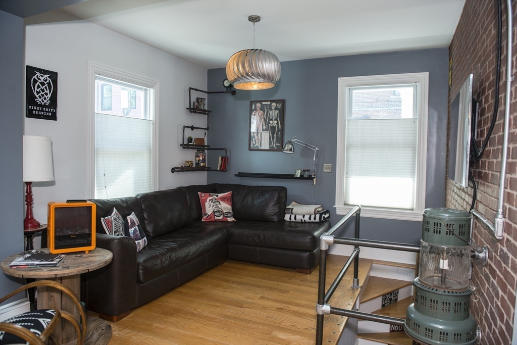 222 Pearl Street, Unit 2 Somerville, MA 02145 - Photo 9 of 15 a living room with furniture a window and a chandelier