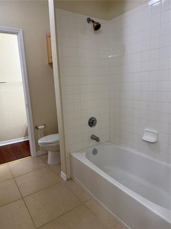 3725 Conroy Road, Unit 2127 Orlando, FL 32839 - Photo 28 of 30 a white bath tub sitting next to a toilet