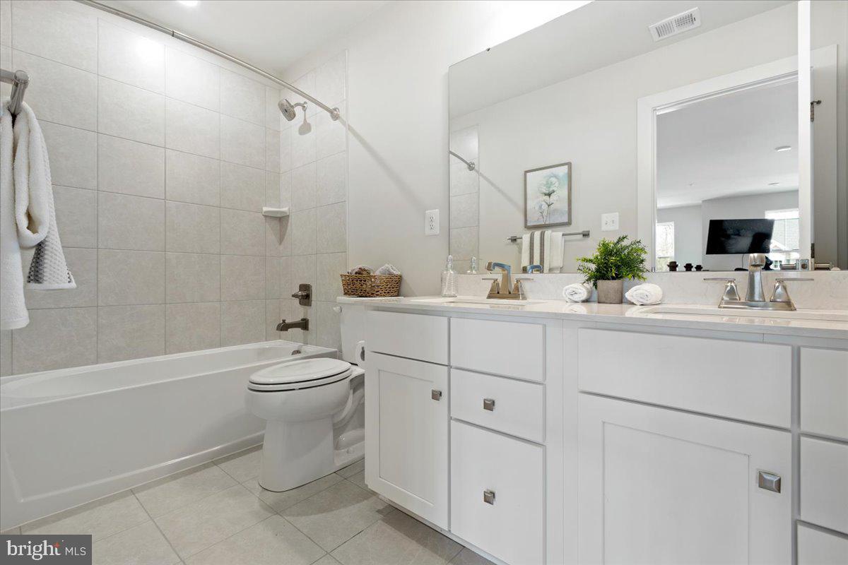 1240 Upper Patuxent Ridge Road Odenton, MD 21113 - Photo 54 of 87 a bathroom with a toilet a sink a tub and mirror