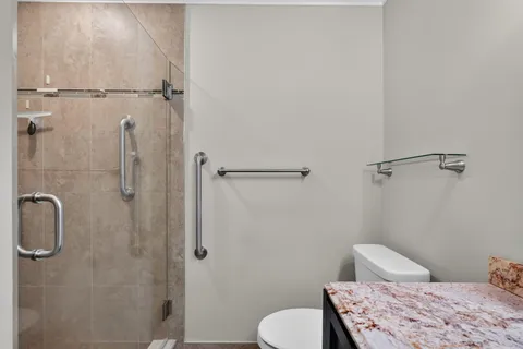 a bathroom with a toilet and a shower