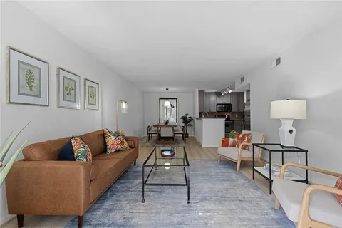 a living room with furniture and a lamp