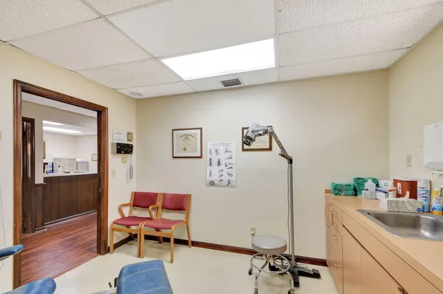 a room with furniture a rug and a chandelier
