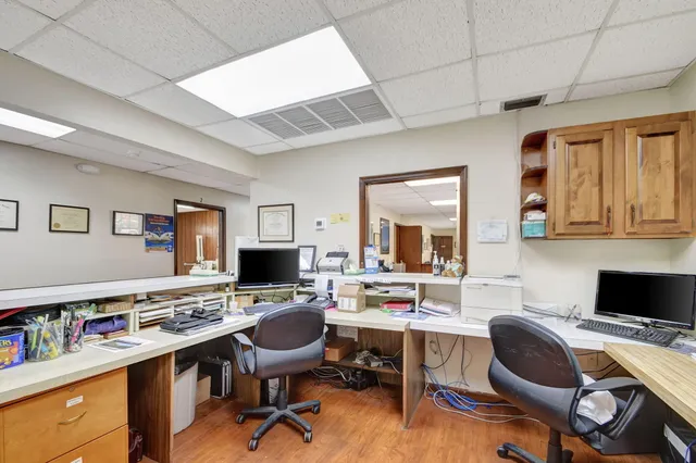 a bedroom with a bed and a flat tv screen next to a window