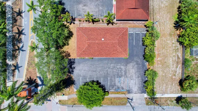 an aerial view of a house with a yard and a fountain