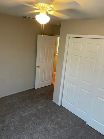 a white toilet sitting next to a bath tub