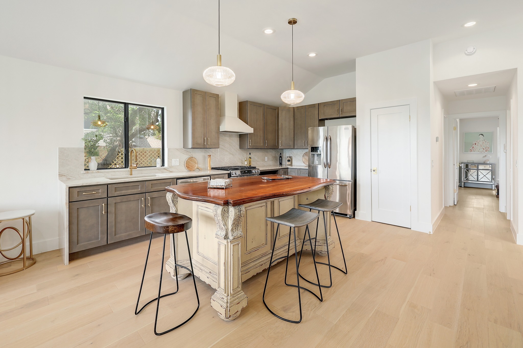 7705 Jester Boulevard Austin, TX 78730 - Photo 8 of 36 Culinary haven with a vintage-inspired island and premium stainless steel appliances.