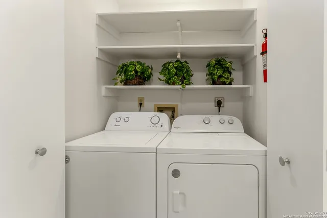 a view of storage and utility room with washer and dryer
