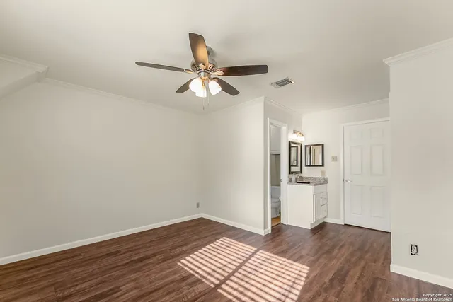 a view of empty room with wooden floor