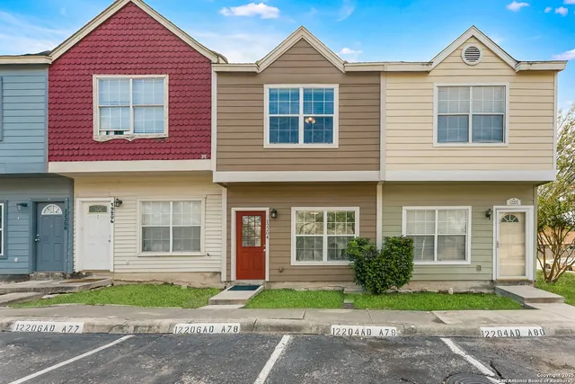 a front view of a house with a yard and a garage