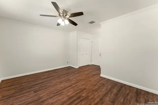 a view of an empty room with wooden floor