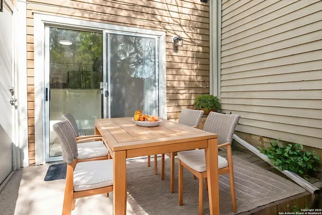 a view of a patio with a dining table and chairs